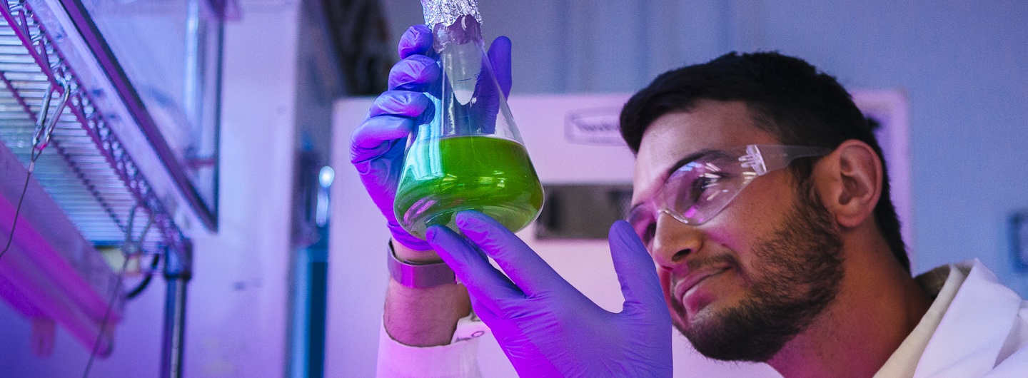 Researcher holding flask